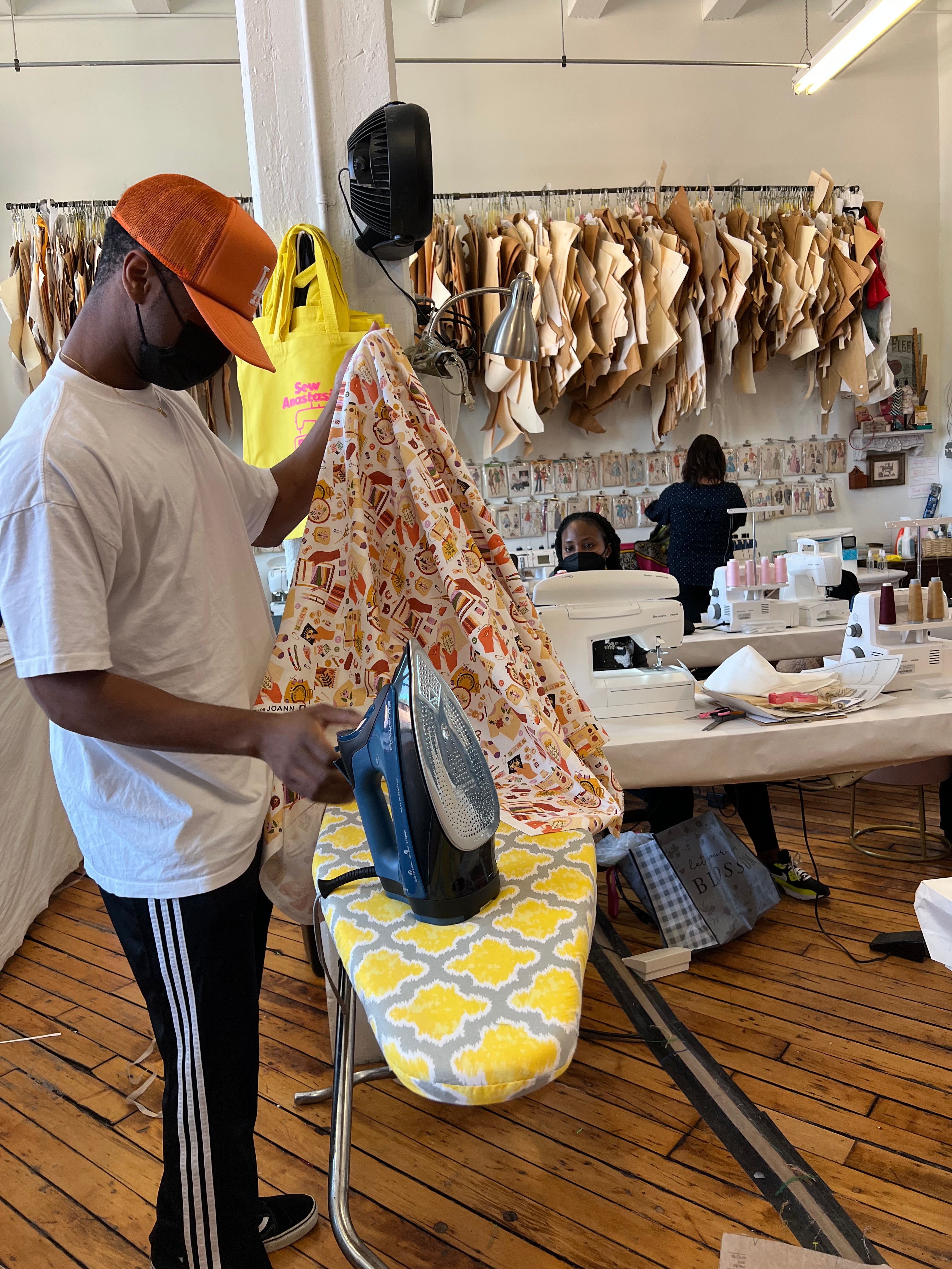 man ironing fabric