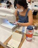 girl with glasses learning how to sew at sew anastasia in chicago